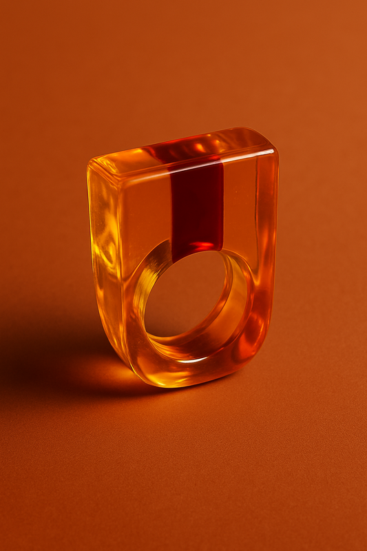 Transparent amber-colored ring on an orange background