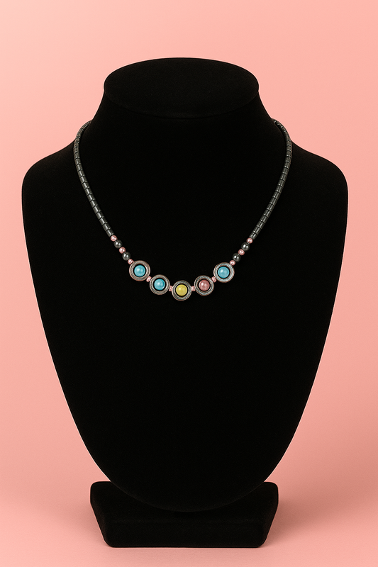Necklace with colorful beads on a black bust against a pink background