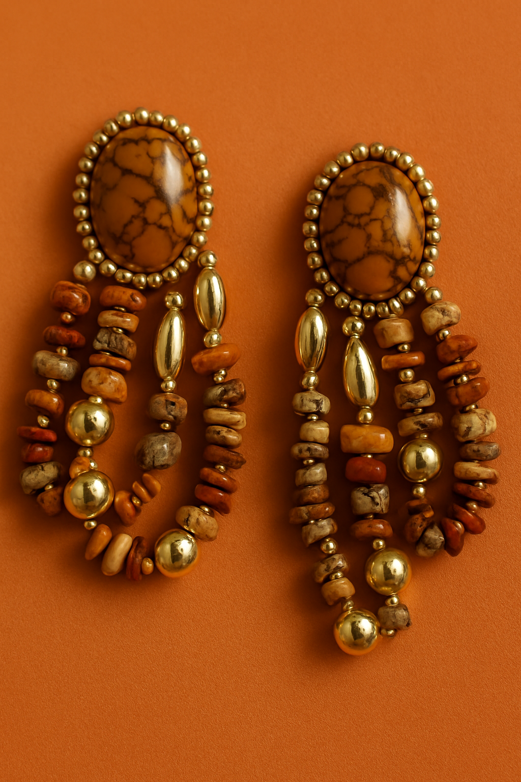 Pair of beaded earrings on an orange background