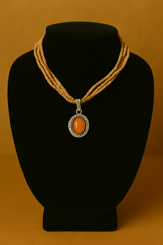 Necklace with a pendant on a black mannequin bust against an orange background
