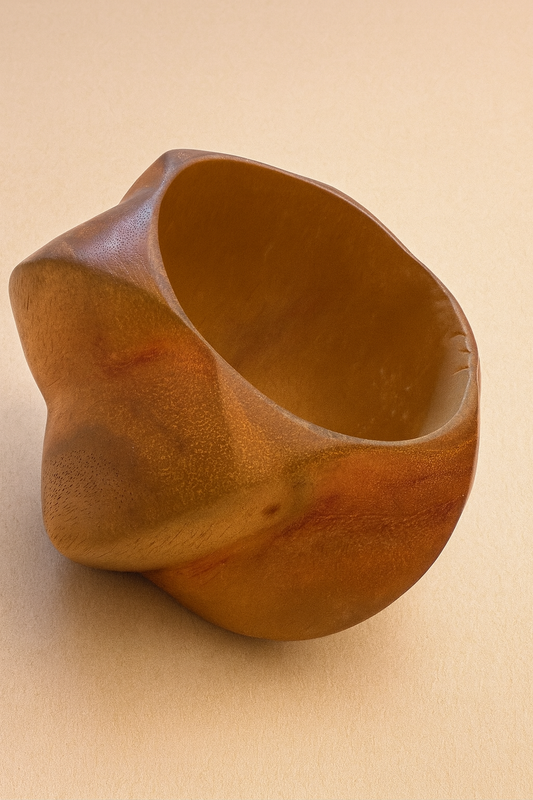 Wooden bowl with a unique, organic shape on a beige background