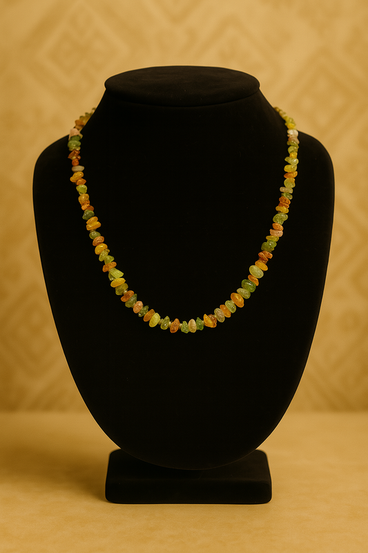Necklace with multicolored beads on a black mannequin bust against a beige background